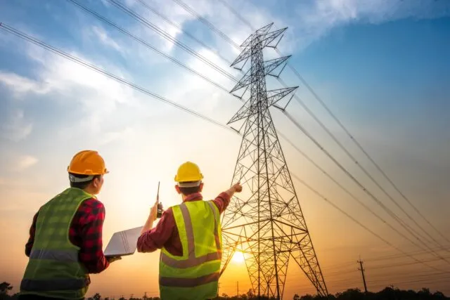 Two engineers reviewing electrical work at a power station
